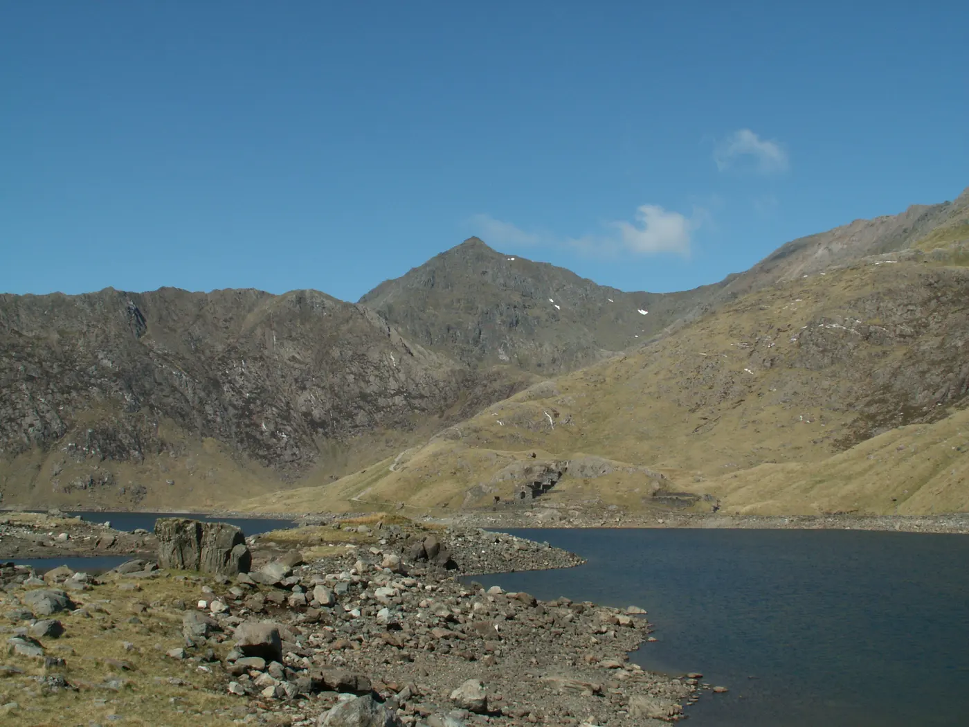 The pointed summit of Yr Wyddfa above Llyn Llydaw in Cwm Dyli