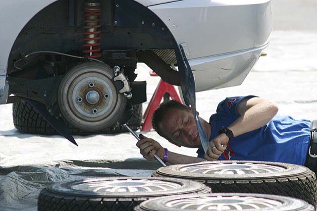 A mechanic servicing a vehicle